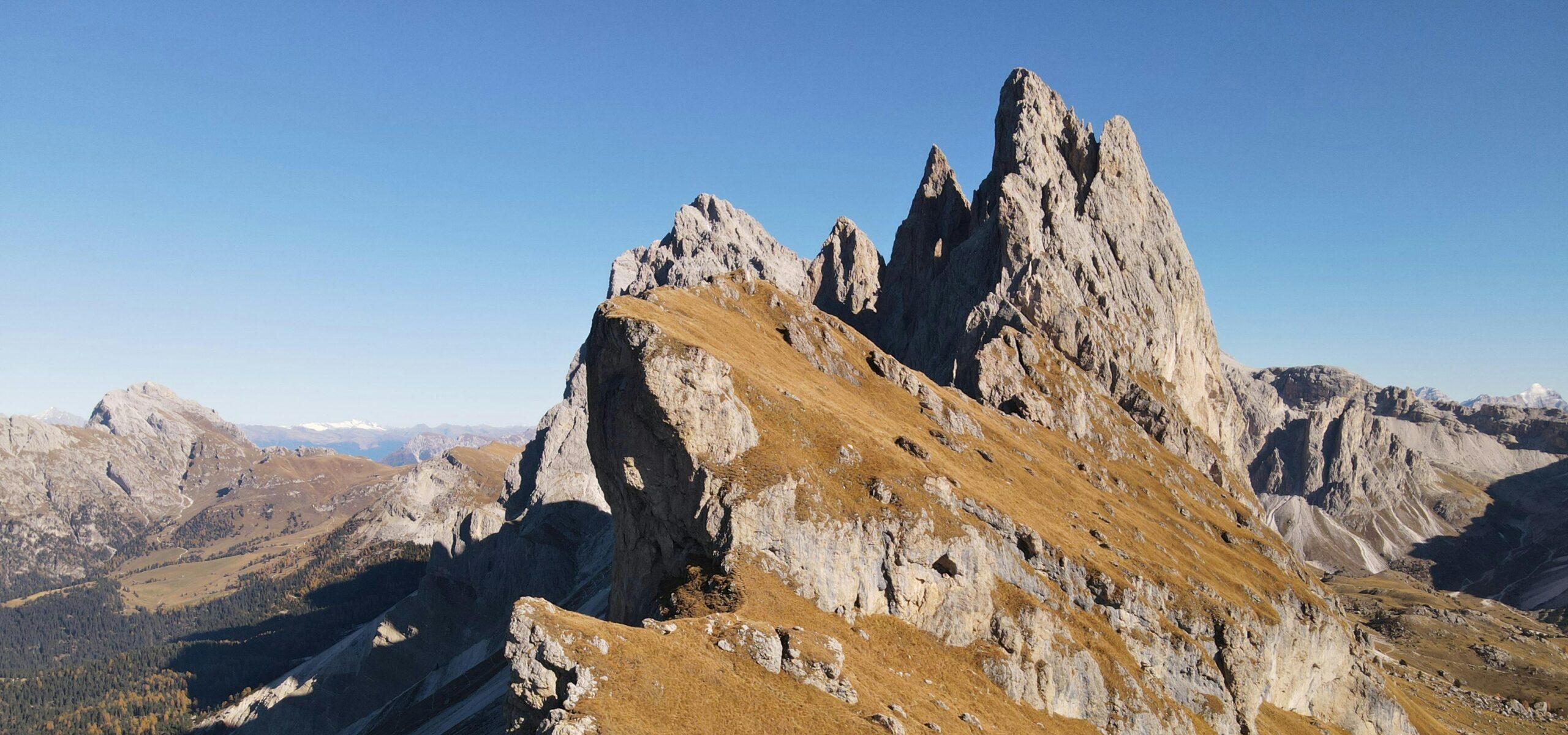 A breathtaking view of rocky peaks in Trentino-Alto Adige under a clear blue sky.
